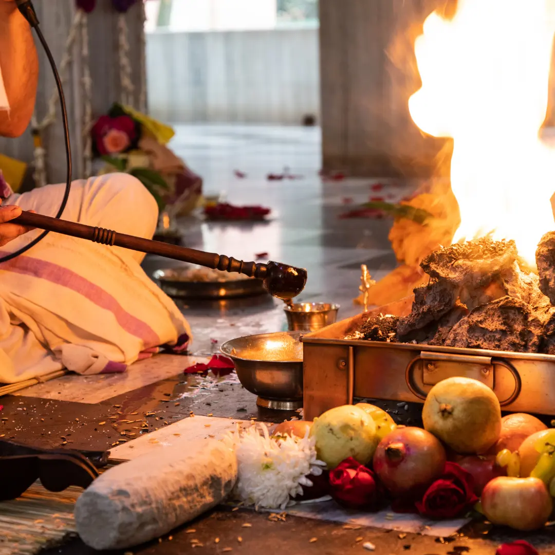 The fire burning in a square kund dressed with marigolds, in Vrindavan