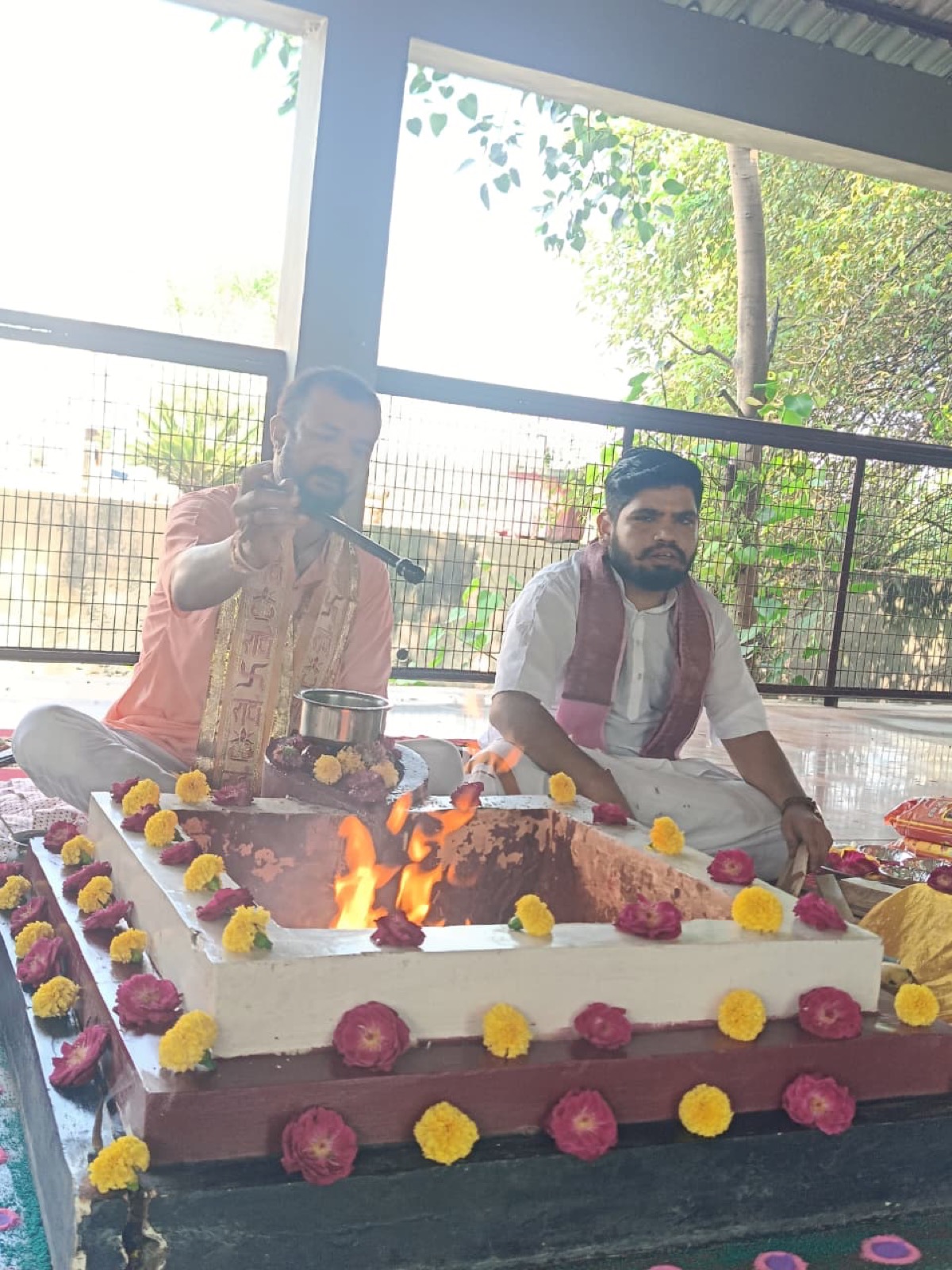 A Brahmin pouring ghee into the flame