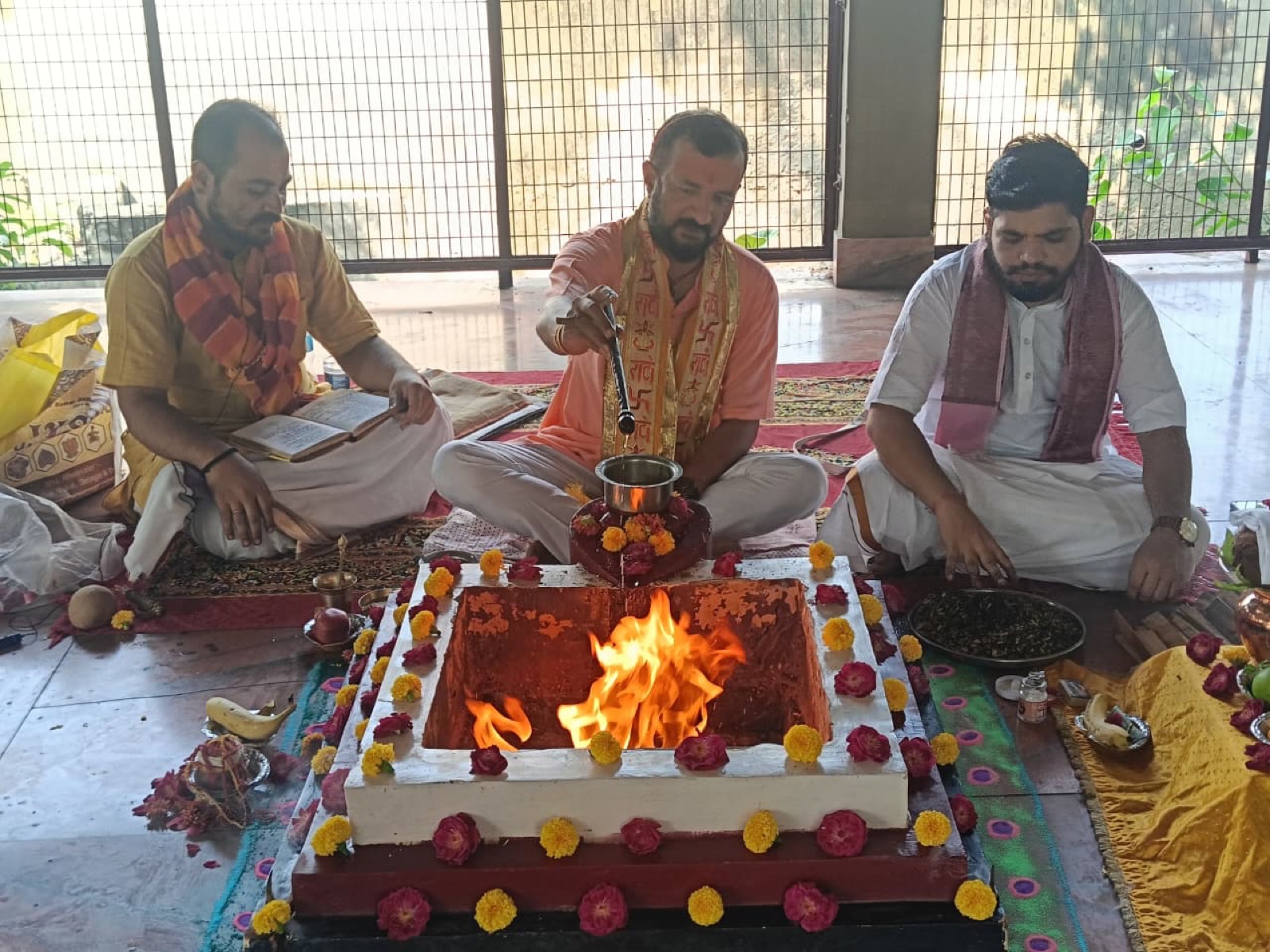 Ghee poured into the fire with a long spoon