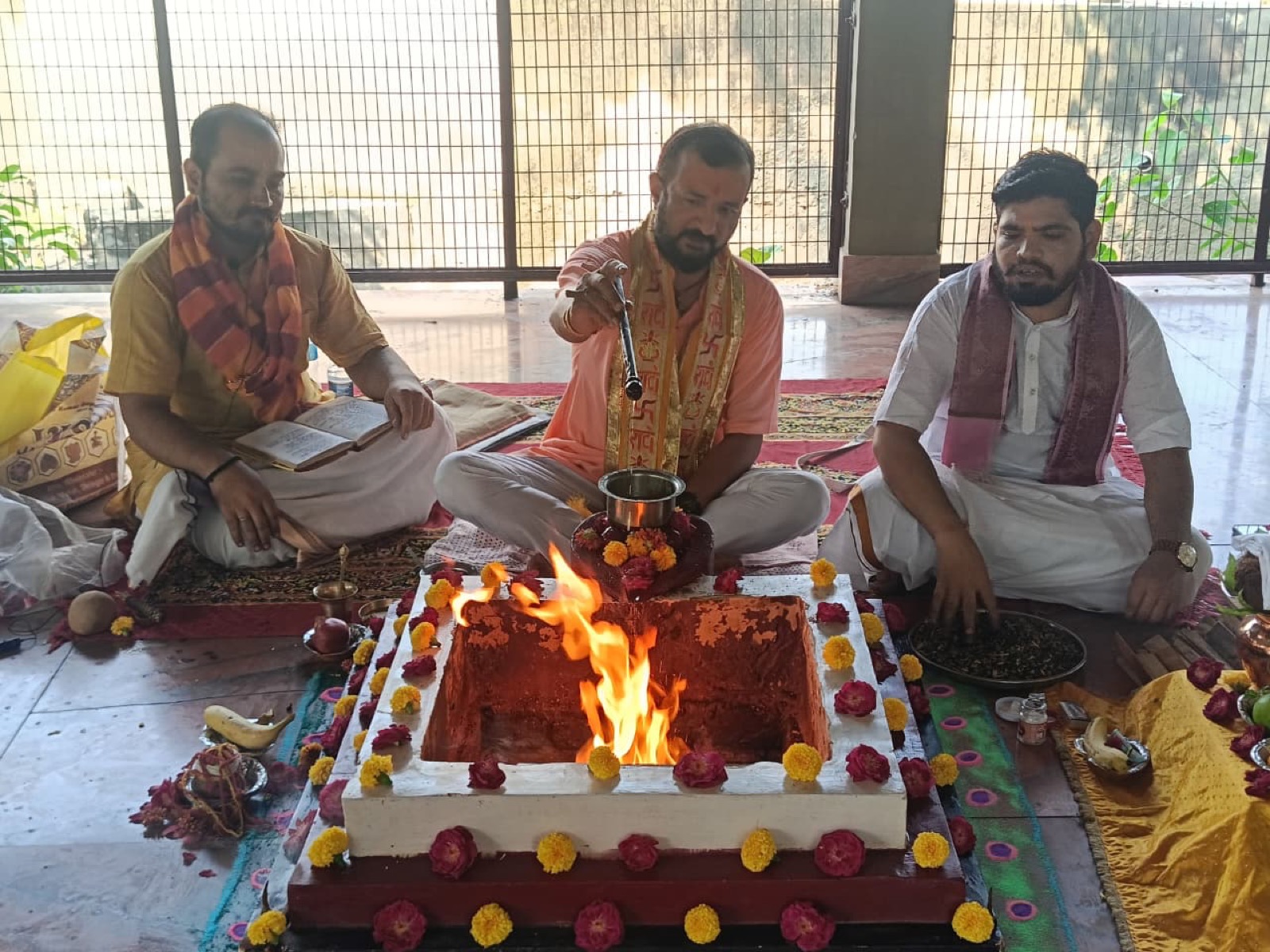 Two Brahmins making an offering together
